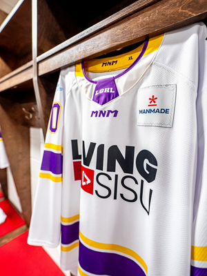 The white LSHL jersey hanging in the dressing room stall with the Manmade team patch