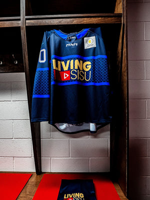 The navy jersey hanging in the dressing room stall